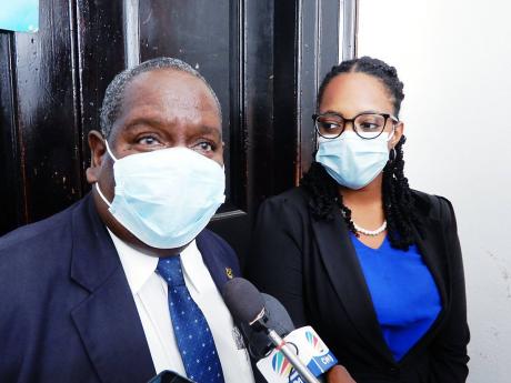 Losing JLP candidate Delroy Granston speaking to the media while his attorney, Dania Allen, looks on at the St Ann’s Bay courthouse on Wednesday. 