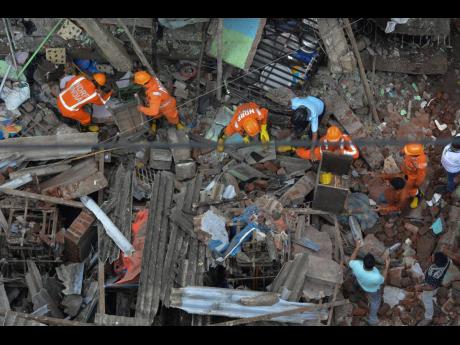Credit: Praful Gangurde Rescuers look for survivors after a residential building collapsed in Bhiwandi in Thane district, a suburb of Mumbai, India, yesterday.