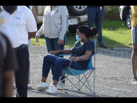 Voters exercised social distancing as they waited in line outside the 
St Andrew Eastern polling station at St Margaret Anglican Church.