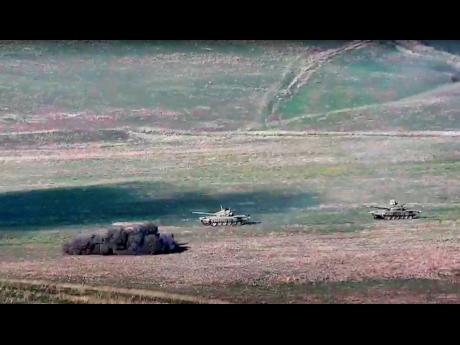 Credit: Armenian Defence Ministry In this image taken from a footage released by Armenian Defence Ministry on Sunday, September 27, 2020, Armenian army destroys Azerbaijani tanks at the contact line of the self-proclaimed Republic of Nagorno-Karabakh, Azerbaijan.