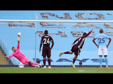 Credit: AP Leicester’s Jamie Vardy (second right) scores his side’s first goal of the game from the penalty spot during their English Premier League match against Manchester City at the Etihad Stadium in Manchester, England, yesterday.