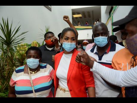 Lisa Hanna is greeted by supporters after the meeting of the PNP National Executive Council ended at the Jamaica Conference Centre on Sunday. 