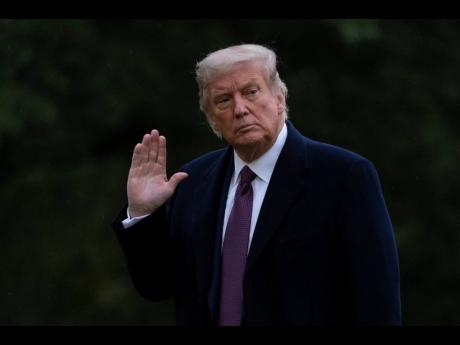 President Donald Trump waves as he walks from Marine One to the White House in Washington, Thursday, October 1, 2020, as he returns from Bedminster, N.J. 