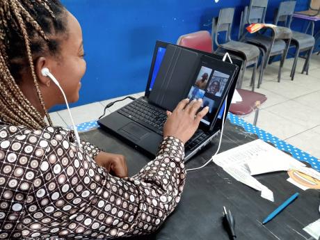 Credit: Photo by Corey Robinson
Camecia Vassell, grade six teacher at St Michael’s Primary, interacting with some of her students during an online class last week.