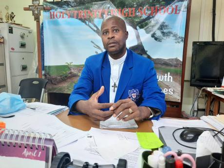 Holy Trinity High School Principal Reverend Carl F. Clarke.