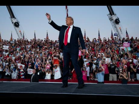Credit: Evan Vucci President Donald Trump arrives for a campaign rally at Orlando Sanford International Airport in Florida on Monday.