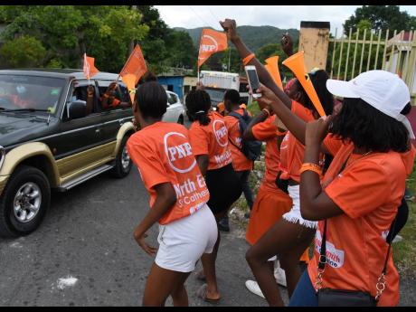 
People’s National Party supporters in Riversdale, cheering the arrival of the motorcade that was touring the constituency of St Catherine North Eastern in August with Dr Peter Phillips, and Oswest Senior Smith, Caretaker Candidate for the constituency.