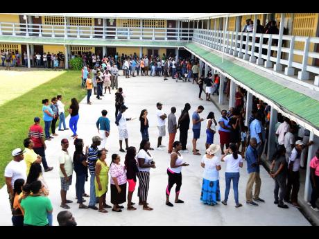 People line up to vote during presidential elections in Georgetown, Guyana, on March 2.