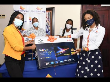 As part of the Guardian Group Foundation’s efforts to assist schools to strengthen their infrastructure to support the blended-learning framework, the Waterford Primary School was the beneficiary of two smart television sets. Pictured are Karen Brown (ri