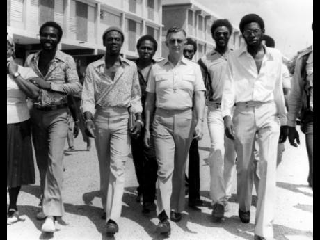 Credit: Gleaner Archive Photo JLP Leader Edward Seaga (third right), accompanied by councillors and party supporters, walks towards the Western returning office at the Denham Town Secondary School, where he was nominated for the October 1980 election.