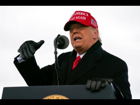 President Donald Trump speaks during a campaign rally at Michigan Sports Stars Park, in Washington, Michigan, on Sunday. (AP)