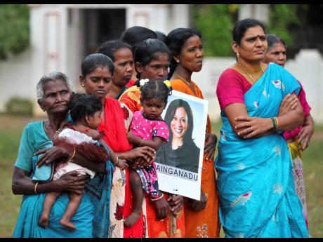 Credit: AP Indian village women, one holding a placard featuring US Vice-President-elect Kamala Harris during celebrations for her victory in Painganadu, a neighboring village of Thulasendrapuram, the hometown of Harris’ maternal grandfather, south of Chennai, Tami