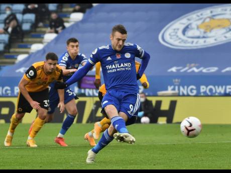 Leicester City’s Jamie Vardy scores the game’s only goal during their English Premier League match against Wolverhampton Wanderers at the King Power Stadium in Leicester, England, yesterday.