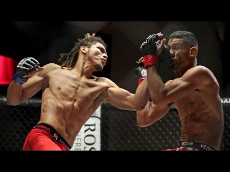 Mixed martial artist Matthew ‘Gold Lion’ Colquhoun (left) strikes Miguel Baeza during an Xtreme Fighting Nation 22 bout in Fort Lauderdale, Florida, on Saturday, December 15, 2018.