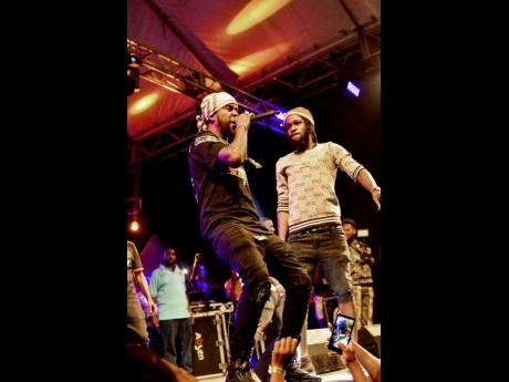 Popcaan performs with his protégé Quada at Ghetto Splash last year December.