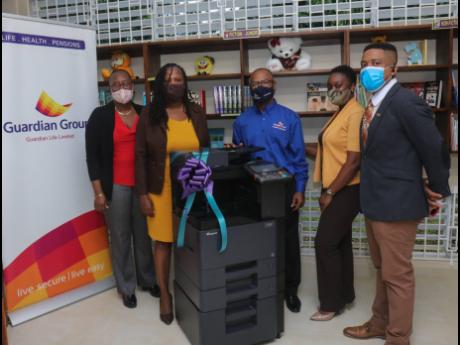 The Green Island Branch Library, Hanover, was recently presented with a printer/copier by the Guardian Group Foundation which was represented by Leroye Morrison (centre) and Lincoln Dickson (right), branch manager and sales adviser, respectively, of the Mo