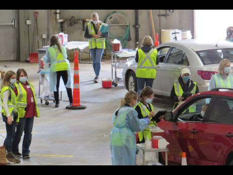 Credit: AP This 2020 photo provided by Carlton County shows their drive-thru flu clinic in Carlton, Minnesota. The facility is a way to social distance in the coronavirus pandemic, but also served as a test run for the COVID-19 vaccines that county health officials s
