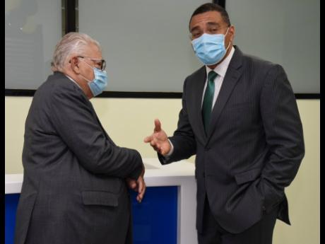 Prime Minister Andrew Holness (right) and Karl Samuda, minister of labour and social security, share a moment during the official opening of Samuda’s ministry’s parish office in St Ann’s Bay, St Ann, on Thursday.