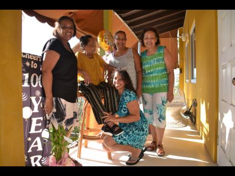 Curline Lyon (second left) celebrates her 100th birthday on Saturday, five days before the actual milestone, with several relatives and friends offering well wishes and blowing kisses in a drive-through. Here she is flanked by (from left) Margaret Rhoden, 