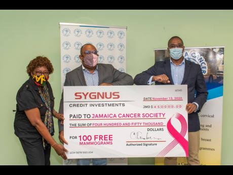 From left: Elve Passley, administrative officer,  Jamaica Cancer Society (JCS); Michael Leslie, acting executive, JCS; and David Cummings, vice-president and head, Real Estate & Project Finance at Sygnus, hold the symbolic cheque which was donated to the J