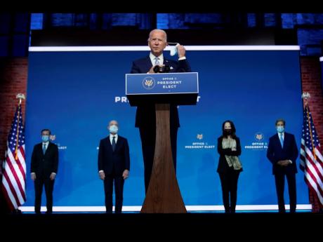 
President-elect Joe Biden removes his face mask as he arrives to introduce his nominees and appointees to key national security and foreign policy posts at The Queen theatre, Tuesday, Nov 24, 2020, in Wilmington, Del. President-elect Joe Biden’s first w