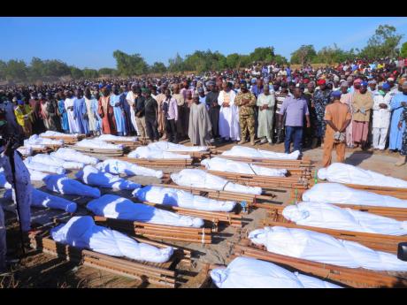 People attend a funeral for those killed by suspected Boko Haram militants in Zaabarmar, Nigeria, yesterday.  