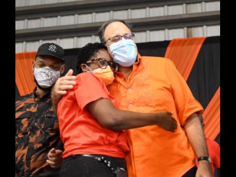 Credit: Rudolph Brown/Photographer Mark Golding, president of the PNP, comforts Angela Brown Burke, who failed in her bid for the chairmanship of the party on Sunday. Also in photo is Raymond Pryce, who was defeated by Dayton Campbell in the race for general secretary.