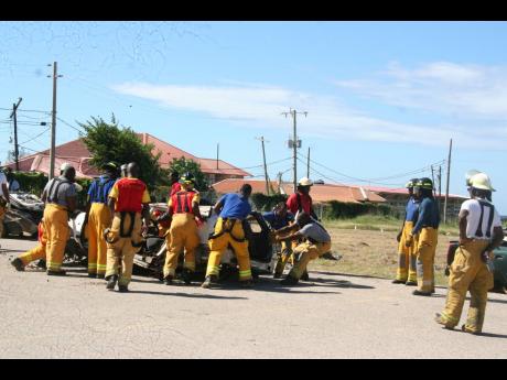 Members of the Hanover branch of the Jamaica Fire Brigade participate in an extrication technique exercise.