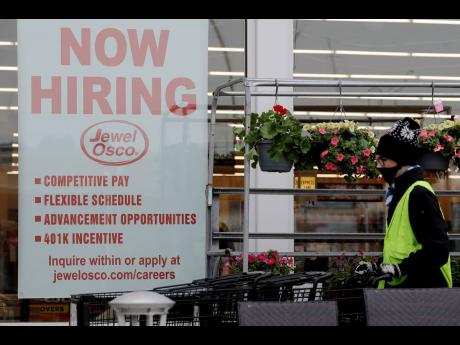 A hiring sign is displayed at a Jewel Osco grocery store in Deerfield, Illinois on April 23, 2020. 