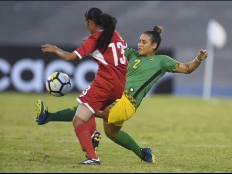 Credit: File Jamaica’s Lauren Silver (right) lunges in on Cuba’s Zallin Rodriguez during their Concacaf Caribbean Women’s Championship match at the National Stadium on Sunday, September 2, 2018.