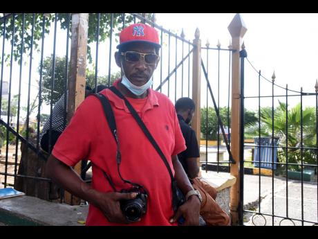 Credit: Kenyon Hemans/Photographer Alan Currie says on some days, he earns as little as $500 for photography services in Mandela Park, Half-Way Tree.
