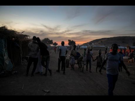 Credit: The Associated Press People who fled the conflict in the Tigray region of Ethiopia walk in Umm Rakouba refugee camp, in Qadarif, eastern Sudan, on Monday.