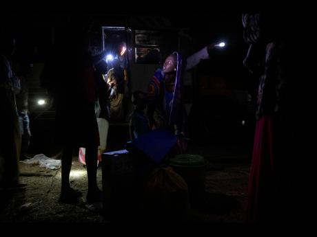 Credit: The Associated Press Tigrinyan refugees who fled Ethiopia's conflict gather their belongings after their arrival from Village 8, the transit centre near the Lugdi border crossing, at Umm Rakouba refugee camp in Qadarif, eastern Sudan, Sunday, Dec 13, 2020. Convoys carrying ove