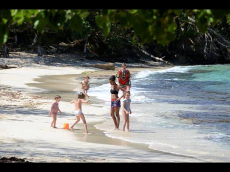 In this file photo visitors are seen at the Winnifred Beach in Portland.