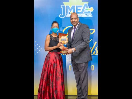Credit: Contributed Ryan Parkes (right), chief of Business Banking at JN Bank, presents Lisa Grant, director of Group Legal Services and Administration at Technological Solutions Limited, with the Pauline Grey Award for Best Support Service, during the 2020 Jamaica Manufactur