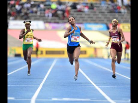 Charokee Young of Hydel (centre) wins the Class One girls’ 400m final with a time of 52.48 seconds at the ISSA/GraceKennedy Boys and Girls’ Athletics Championships at the National Stadium on Saturday, March 30, 2019.