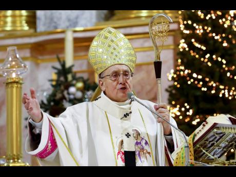 Credit: AP Belarus Roman Catholic Archbishop Tadeusz Kondrusiewicz leads a Christmas midnight mass at the Church of Saints Simon and Helena during in Minsk, Belarus on Christmas Eve.
