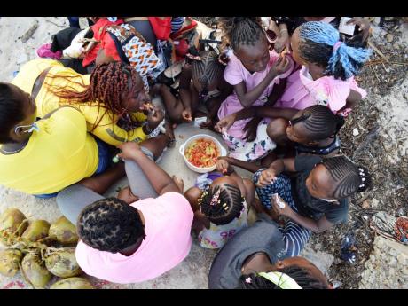Credit: AP
Children with their parents enjoy the meal the Jomo Kenyatta public beach on Christmas day in Mombasa, Kenya. Despite the World Health Organization’s guidelines, many of the holiday makers had no masks on their faces or kept social distance which might