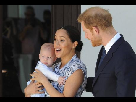 Credit: AP Britain’s Prince Harry and Meghan, Duchess of Sussex, holding their son Archie.
