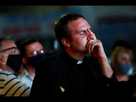 A Catholic priest reacts during a demonstration against the decriminalisation of abortion on Tuesday.