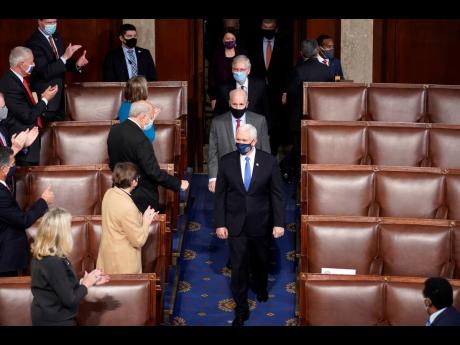 Credit: AP Vice President Mike Pence arrives with members of the Senate to officiate as a joint session of the House and Senate convenes to count the electoral votes cast in November’s election, at the Capitol yesterday.