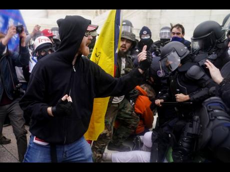 Trump supporters try to break through a police barrier on Wednesday at the Capitol in Washington. 