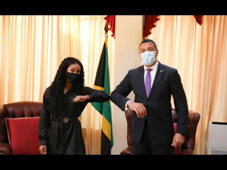 National sprinter Briana Williams (left) and Prime Minister Andrew Holness during a courtesy call at his office on Thursday.