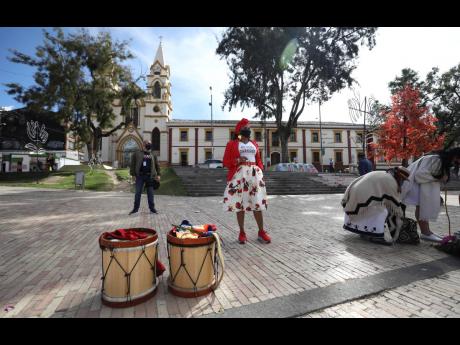 Escorted by a government-assigned bodyguard, community leader Luz Nelly Santana arrives for a meeting with other leaders who, like her, have had their lives threatened by illegal armed groups in Bogota, Colombia, on Thursday, December 17, 2020. Santana sur
