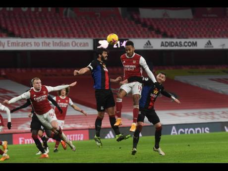Credit: AP Arsenal’s Pierre-Emerick Aubameyang (centre) jumps for the ball during their English Premier League match against Crystal Palace at Emirates Stadium in London, England, yesterday.