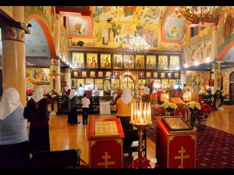 Parishioners worship during a Christmas Eve service at the Russian Orthodox Church of the Nativity on Wednesday, January 6, 2021, in Erie, Pennsylvania.