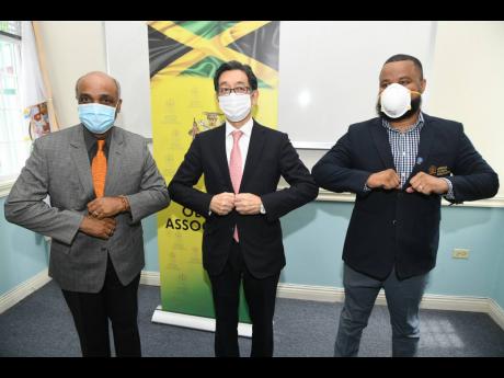 
Ambassador Masaya Fujiwara (centre) with Ryan Foster (right), secretary general/CEO, and Christopher Samuda, president of Jamaica Olympic Association (JOA), during a courtesy call at JOA office in September 2020.