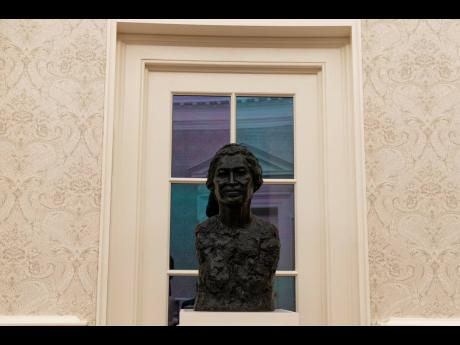 A bust of civil rights leader Rosa Parks sits atop a plinth inside the Oval Office. 