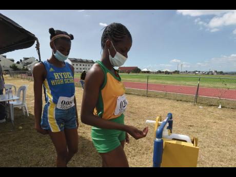 
Athletes sanitise their hands during the Tyser Mills Classics at Calabar High School on Saturday, December 12, 2020. 