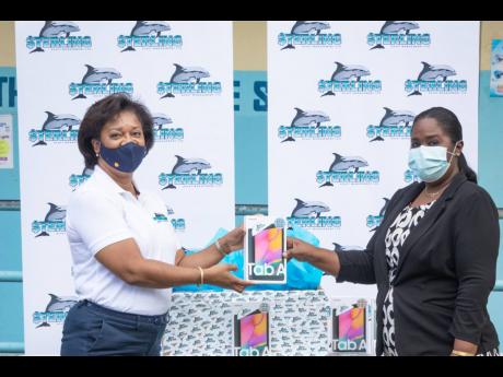 Sterling Asset Management donated over $630,000 in tablets and cases to benefit the grade 11 students attending Annotto Bay High School in St Mary. Michelle Valentine (left), Sterling’s newly appointed assistant vice-president of marketing, makes the pre